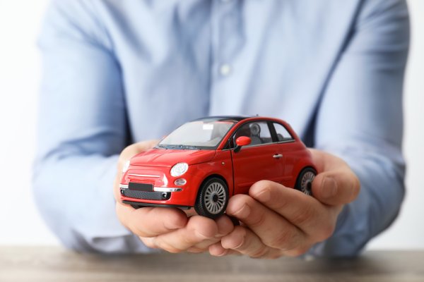 carchex overview extended car warranty provider man in blue shirt holding red toy car in hands